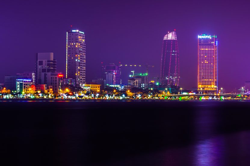 The Da Nang skyline at night along the Han River, with the Han River Bridge lit on the right